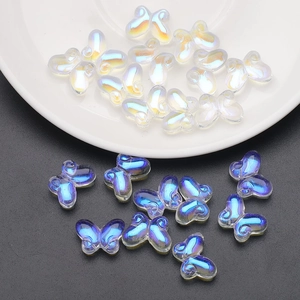 Macro view of butterfly glass beads in iridescent white and blue for DIY jewelry