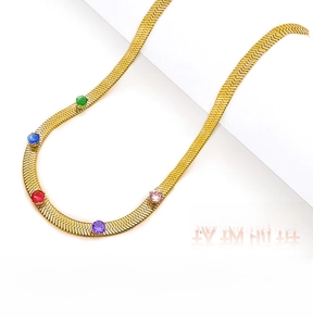 Detail of gold snake chain necklace with five multi-colored round zircon gemstones