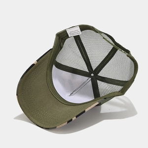 Detail view of trucker hat mesh back and interior label showing 50% cotton blend fabric