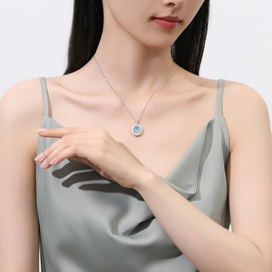 S925 sterling silver necklace with blue emerald-cut pendant on a model in silk dress
