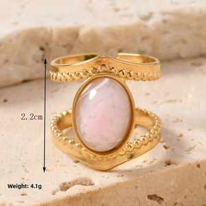 Macro shot of vintage gold steel ring with pink oval stone showing 2.2cm height