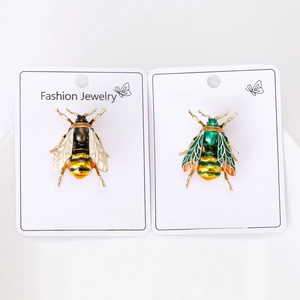 Detailed view of fashion enamel bee brooches with rhinestones on display cards
