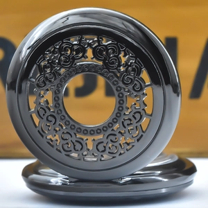 Close-up of vintage glossy black hollow-out floral pattern pocket watch cover