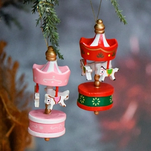 Festive Christmas carousel ornaments in pink and red-green hanging on pine branches