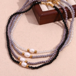 Detail of beaded necklaces with freshwater pearls and crystals in black and grey