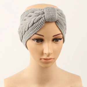 Close-up of light grey knit headband showing detailed cable stitch texture on a mannequin