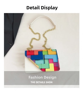 Detail of color-block geometric handbag with asymmetrical flap and gold chain strap