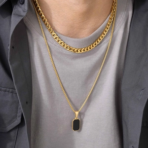 Men's gold Cuban chain and black rectangular pendant necklace set in a layered fashion look