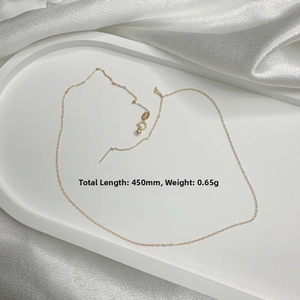 Detail of a gold-plated 450mm adjustable needle chain necklace on a silk background