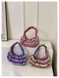 Detailed close-up of rainbow gradient pleated shoulder bag showing satin-like texture