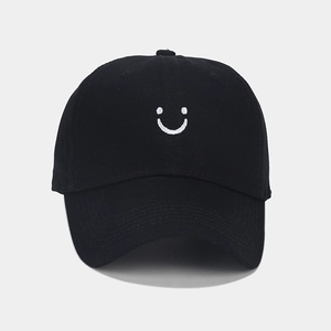 Classic black cotton baseball cap with white smiley face embroidery and curved brim