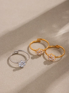 Macro shot of 18k gold plated flower rings with drop-shaped zircon inlays on stone