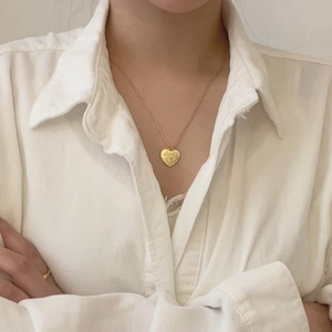 925 sterling silver heart pendant necklace in gold finish worn by a model