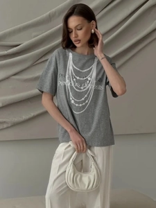 Detail of grey cotton T-shirt featuring a white pearl necklace print and graphic text