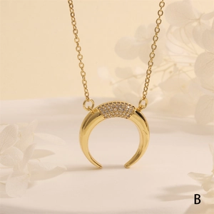Detail of 18k gold plated crescent moon pendant with micro-paved zircons and fine chain