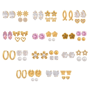 Set of three luxury gold earrings featuring pearls, zircons, flowers and heart shapes