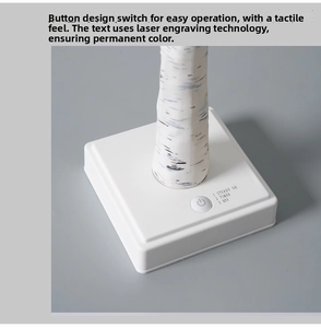 Detail of white birch tree lamp base with laser-engraved steady, timer, and off functions