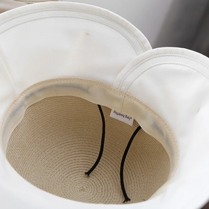 Macro detail of breathable straw lining and adjustable windproof strap on sun hat