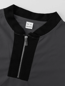 Detail of grey waffle knit polo collar with metal zipper and size M garment label