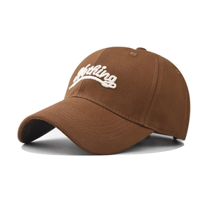 Close-up of white 3D Nothing embroidery on a premium brown cotton baseball cap