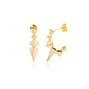 Macro detail of geometric gold earrings with cream enamel and sunburst jagged edges