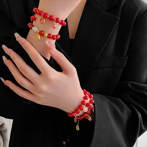 Multi-layer red beaded bracelet with golden Fu character pendant for lunar new year style