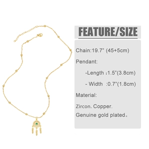 Detail of dreamcatcher necklace with green zircon inlay and gold-plated feather charms