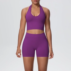 Detailed texture of seamless ribbed fabric on dark purple yoga crop top and high waist shorts