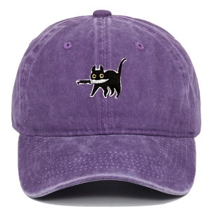 Macro view of black cat embroidery holding a knife on purple washed cotton baseball cap