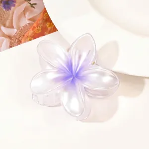 Detail of purple gradient flower hair claw clip with a pearlescent finish and acrylic texture