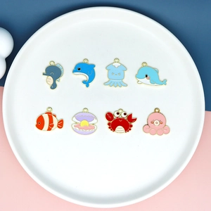 DIY colorful enamel ocean animal pendants for jewelry making on a white plate