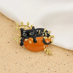 Creative black cat brooch with orange sun and golden leaves on white silk