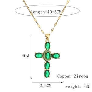 Detail of copper cross pendant featuring five large green oval zircons and gold chain