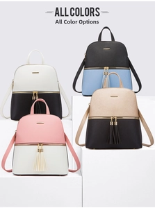 Multiple fashion backpacks in various colorways displayed on a geometric tiered stand