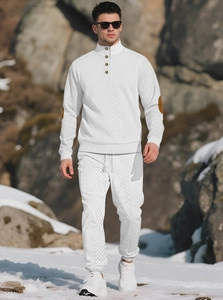 Detail of white waffle knit texture and brown elbow patches on a men's tracksuit set