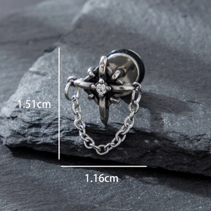 Gothic stainless steel cross earring with chain and zircon on a dark stone background