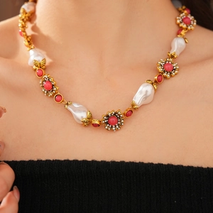 Detailed view of luxury vintage necklace with baroque pearls and rhinestone flowers on neck