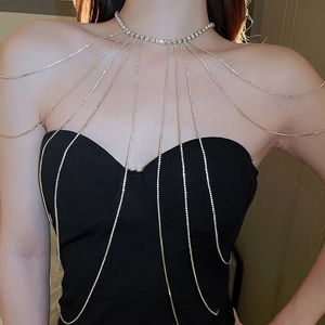 Detail of bridal silver rhinestone body chain with cascading tassel fringe across shoulders