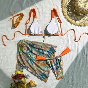 Detailed flat lay of a 3-piece paisley print bikini set with matching sarong wrap