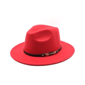 Close-up of bright red fedora hat with black leather strap and gold metal buckle detail