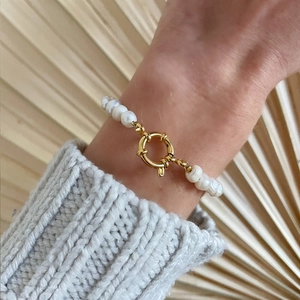 Baroque freshwater pearl bracelet on a model wrist with a large golden spring clasp detail