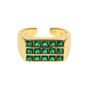 Macro detail of 18K gold plated ring featuring three rows of square green emerald-style gems