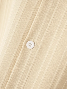 Macro shot of vertical striped cotton linen fabric with a classic white button detail