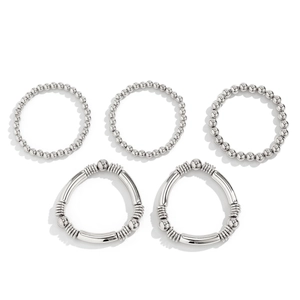 Detail view of five-piece silver beaded stretch bracelets and textured metal bangles set