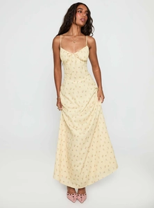 Detailed view of yellow floral midi dress with ruching and delicate spaghetti straps