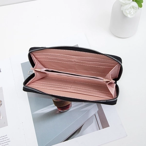 Black quilted zip-around long wallet for women with pink interior and multiple card slots