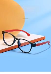 Close-up of kids anti-blue light glasses with black frame and red temples in creative setup