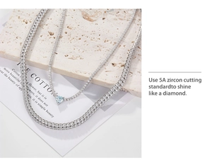 Detail showing blue heart-shaped 5A zircon pendant and sparkling double-row tennis chain