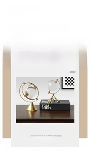 Close-up of golden metal iron art rotating crystal ball ornaments on a wooden table