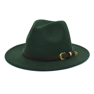 Detail of dark green wool fedora hat featuring a brown leather belt with ornate gold buckle